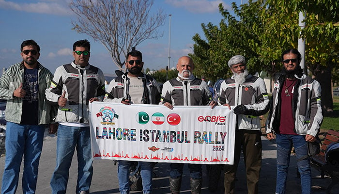 The Pakistani bikers pose for a group photo. — APP