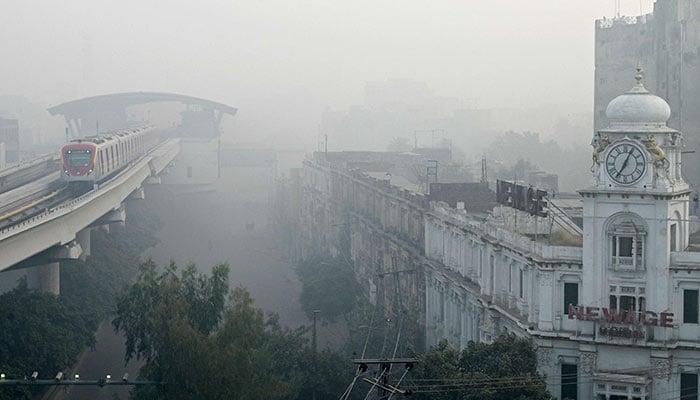 An Orange Line Metro Train is pictured on an elevated track amid smoggy conditions in Lahore on on November 3, 2024. — AFP