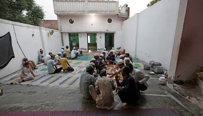 Muslims eat their Iftar (breaking of fast) meal during the holy month of Ramadan inside a madrasa that also acts as a mosque in village Nayabans in the northern state of Uttar Pradesh, India May 9, 2019. — Reuters