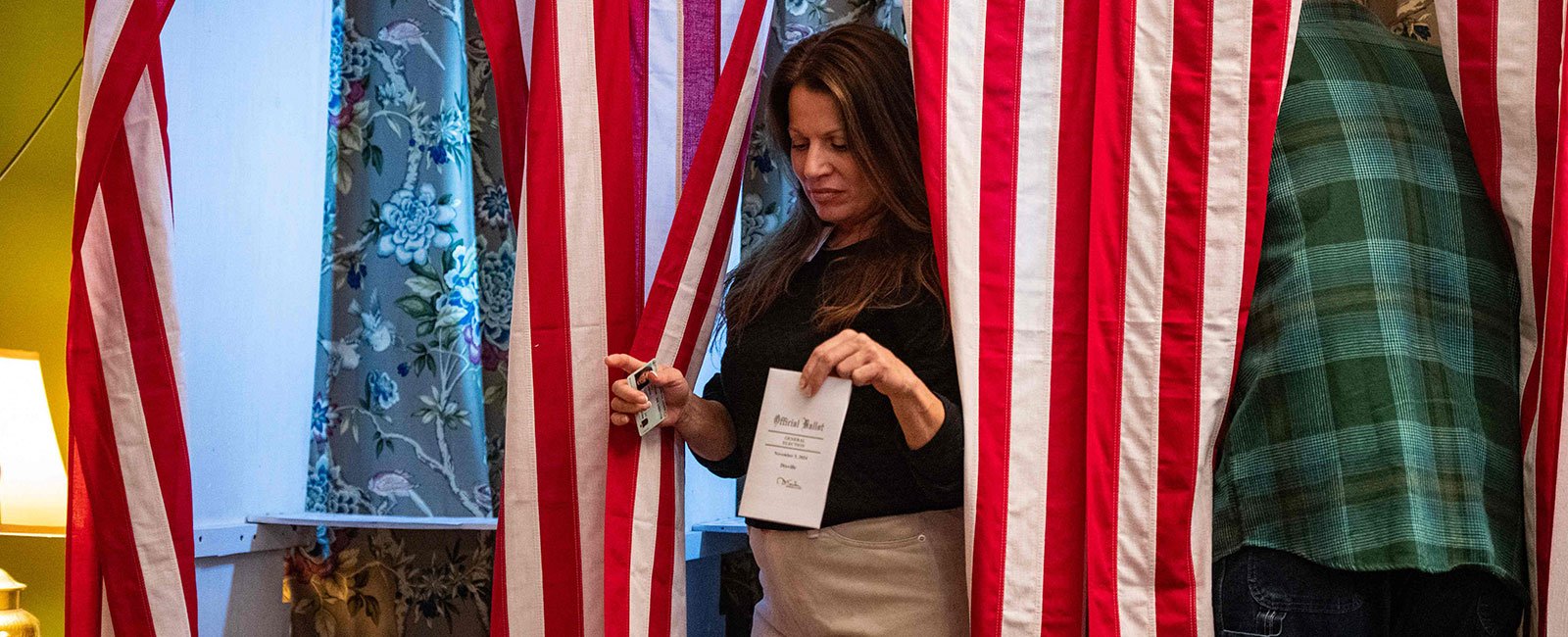 Dixville Notch residents cast their US election ballots at midnight in the living room of Tillotson's home at Balsams Grand Resort, marking the first votes in the US election, in Dixville Notch, New Hampshire on November 5, 2024.