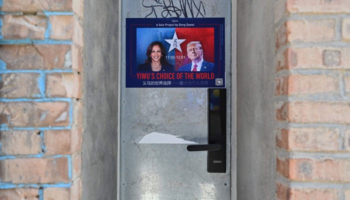 This picture shows a poster of an exhibition by Chinese artist Dong Dawei titled Yiwus choice of the world, a collection of US election merchandise made in Yiwu - a manufacturing hub in eastern Chinas Zhejiang province, outside a gallery in Beijings 798 art district on November 5, 2024. — AFP