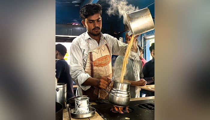 Abdul Qadir makes chai at the Khalil Bhai Chai shop in University of Karachis Prem Gali. — Photo by author