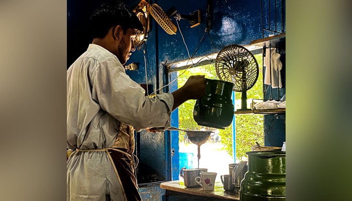 Abdul Qadir prepares chai at the Khalil Bhai Chai shop in University of Karachis Prem Gali. — Photo by author