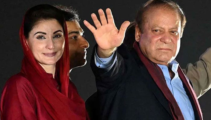 Former prime minister Nawaz Sharif (right) stands beside his daughter Maryam Nawaz  as he waves to his supporters gathered at a park during an event held to welcome him in Lahore on October 21, 2023. —AFP