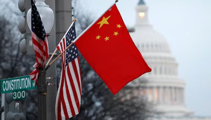 The Peoples Republic of China flag and the US Stars and Stripes fly on a lamp post along Pennsylvania Avenue near the US Capitol in Washington during Chinese President Hu Jintaos state visit, on January 18, 2011. — Reuters