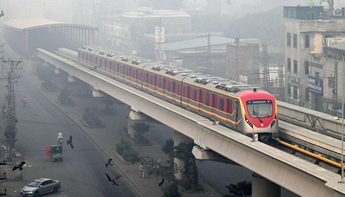 An Orange Line Metro Train (OLMT) is pictured on an elevated track amid smoggy conditions in Lahore on on November 3, 2024. — AFP