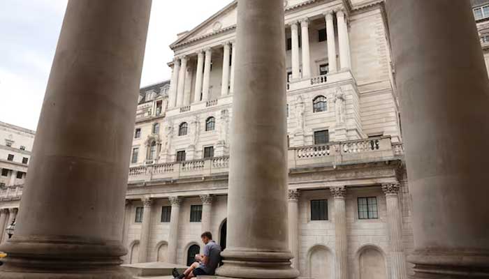 A man sits by the Bank of England in the financial district of London, Britain, August 14, 2024. — Reuters