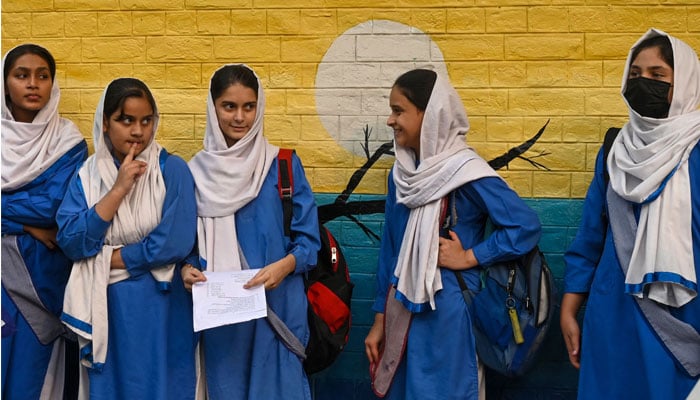 Students leave after attending their school in Lahore on November 6, 2024, as government authorities ordered closing all higher secondary schools over soaring pollution levels. — AFP