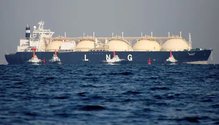 A liquefied natural gas (LNG) tanker is tugged towards a thermal power station. — Reuters/File