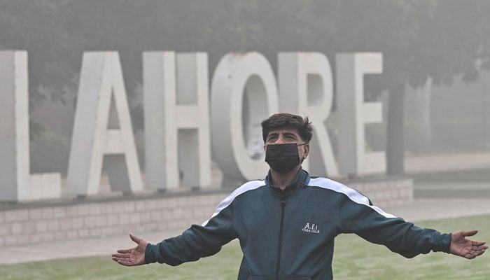 A man exercises in a park amid heavy smoggy conditions in Lahore on November 7, 2024. — AFP