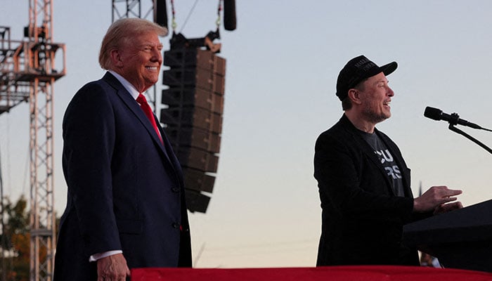 Tesla CEO and X owner Elon Musk speaks as US President-elect Donald Trump looks on during a rally at the site of July assassination attempt against Trump, in Butler, Pennsylvania, US, October 5, 2024. — Reuters