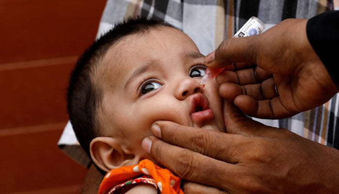 A girl receives polio vaccine drops, during an anti-polio campaign, in a low-income neighborhood in Karachi, July 20, 2020. — Reuters