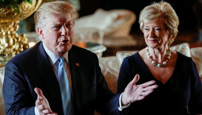 President-elect Donald Trump speaks to reporters as Linda McMahon sits next to him at Trump's Mar-a-Lago ranch in Palm Beach, Florida, in 2019. – Reuters