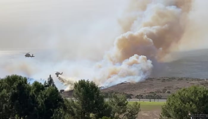 Firefighting helicopters operate as a wildfire burns in Malibu, California, US, on November 6, 2024 in this still image obtained from social media video. —Reuters