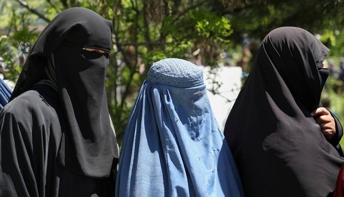 Afghan women wait to receive wheat during a quarantine in Kabul, Afghanistan April 21, 2020. — Reuters