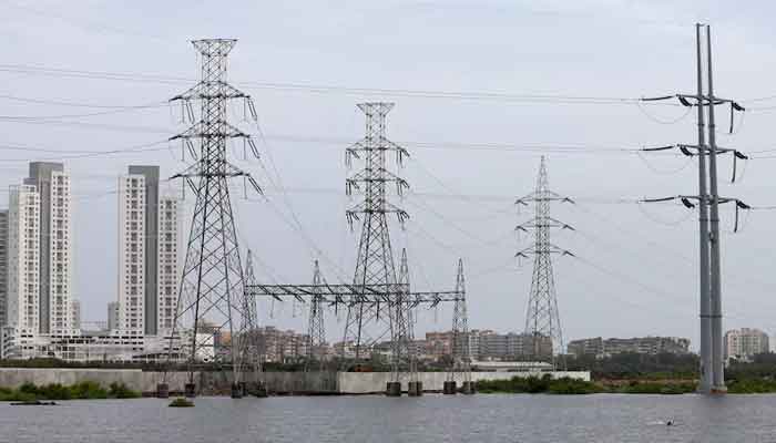 Power transmission towers are pictured in Karachi. — Reuters