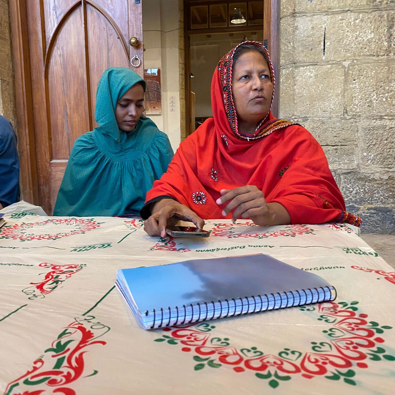 Fatima Majeed speaks while sitting on The Table — a project space at Biennale 2024. — Reporter