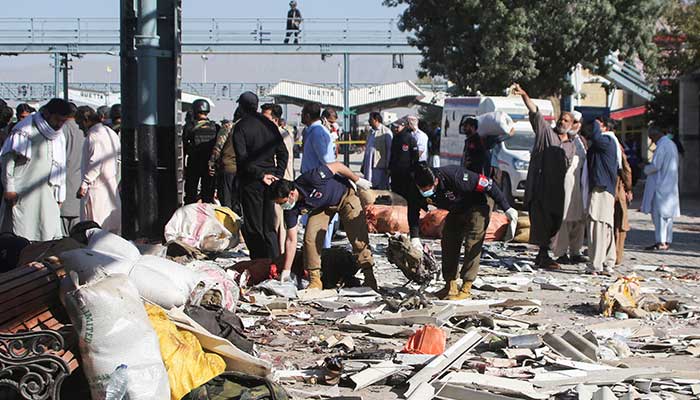 Police officers collect evidence amid the debris after a bomb blast at a railway station in Quetta, November 9, 2024. — Reuters