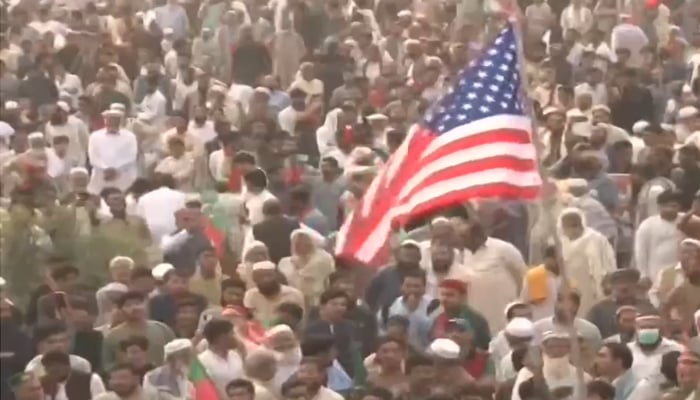 A PTI workers waives US flag at the partys rally in Swabi, on November 9, 2024. — Screengrab/Geo News