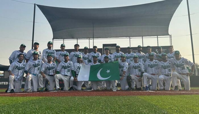 An undated image shows Pakistans baseball team poses with national flag Arab Classic Dubai 2024 championship. — APP/File