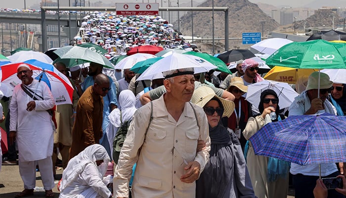 Muslim pilgrims walk with umbrellas on the third day of the Satan stoning ritual, amid extremely hot weather, during the annual haj pilgrimage, in Mina, Saudi Arabia, June 18, 2024. — Reuters