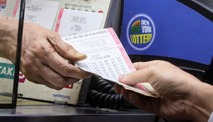 A customer purchases a ticket for the Power-ball jackpot of $1.9 billion dollars at a newsstand in New York City, US, November 7, 2022. — Reuters