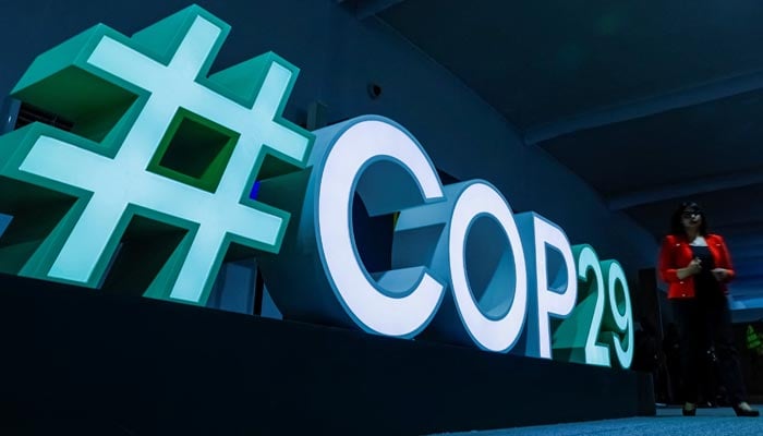 A woman passes by a #COP29 sign during the United Nations climate change conference COP29 in Baku, Azerbaijan November 11, 2024. — Reuters