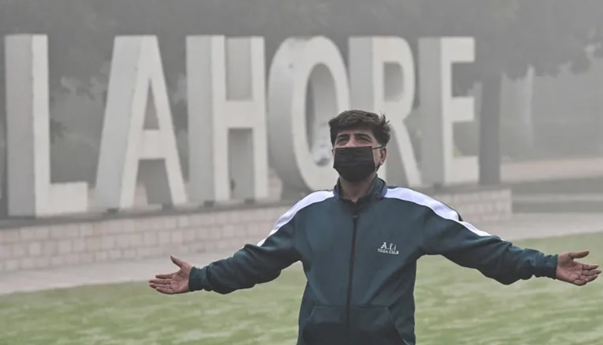 A man exercises in a park amid heavy smoggy conditions in Lahore. — AFP/File