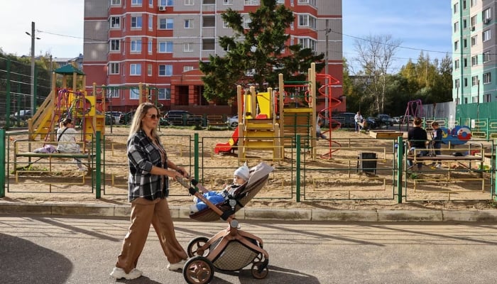 Blogger and marketer Alina Rzhanova, 33, walks with her eight-month-old son Igor during an interview with Reuters in the city of Yaroslavl, Russia October 3, 2024. — Reuters