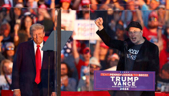 Tesla CEO and X owner Elon Musk speaks as Republican presidential nominee and US president-elect Donald Trump looks on during a rally at the site of the July assassination attempt against Trump, in Butler, Pennsylvania, US, October 5, 2024. — Reuters