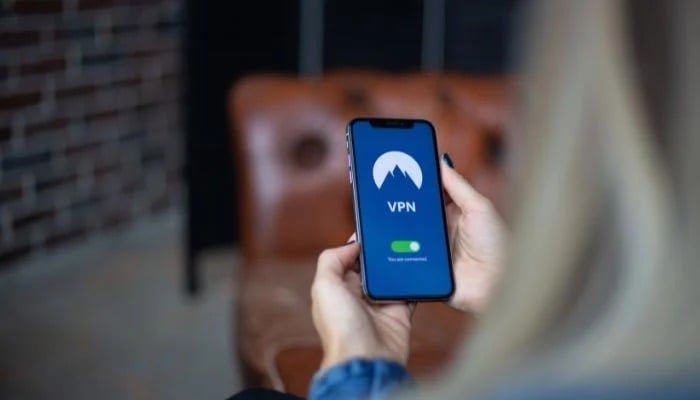 The picture shows a person using VPN on mobile phone. — Canva/File