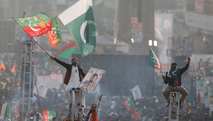 Supporters Imran Khan sit on scaffoldings in Rawalpindi, on November 26, 2022. — Reuters