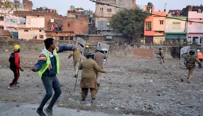 Police officers throw stones towards the demonstrators during a protest against a government demolition drive, in Haldwani in the northern state of Uttarakhand, India, February 8, 2024. — Reuters