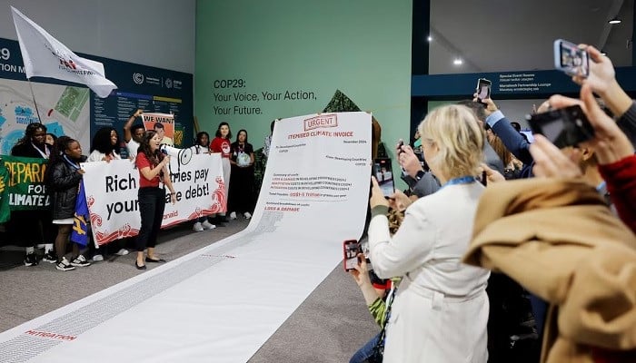 Activists display a 10m long climate invoice directed at developed countries at a protest during the UN COP29, in Baku, Azerbaijan November 14, 2024. — Reuters