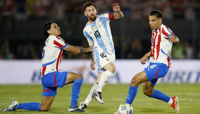 Argentinas Lionel Messi (centre) in action with Paraguays Gustavo Gomez (left) and Diego Gomez during their South American Qualifiers match at Estadio Defensores del Chaco, Asuncion, Paraguay on November 14, 2024. — Reuters