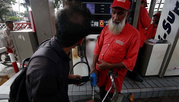 A worker filling petrol in vehicle, at Fuel Station in Karachi, April 16, 2024. — PPI