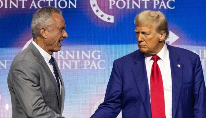 Donald Trump, right, shakes hands with US politician Robert F Kennedy Jr during a campaign rally at the Gas South Arena, in Duluth, Georgia on October 23, 2024.— AFP