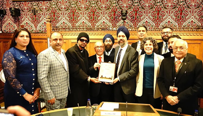 Rapper Bohemia (third from left) receives an award from Tanmanjeet Singh Dhesi MP in this undated photo. — Reporter