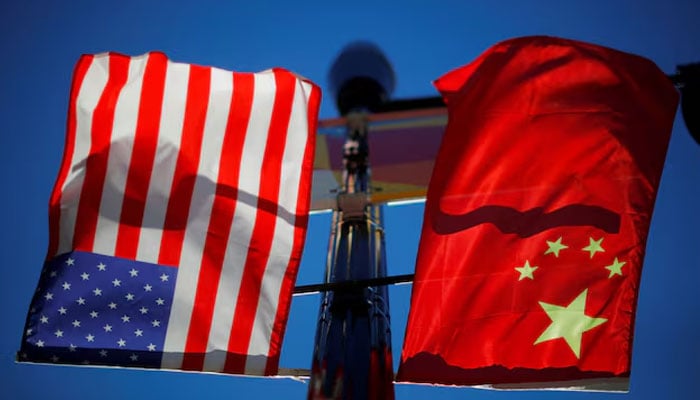 The flags of the United States and China fly from a lamppost in the Chinatown neighborhood of Boston, Massachusetts, US., November 1, 2021.— Reuters