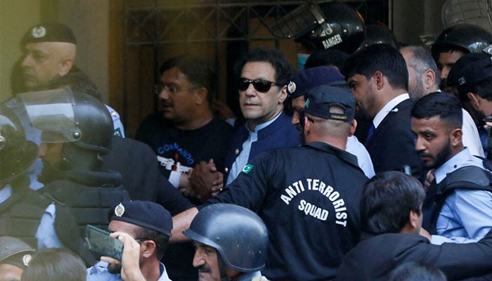 Security officers escort former prime minister and PTI founder Imran Khan, as he appeared in Islamabad High Court. — Reuter/File