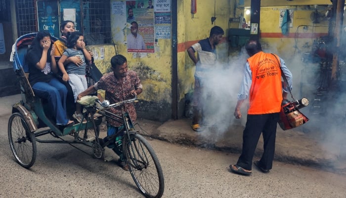 A city corporation worker sprays fumigator to control mosquitoes in Dhaka, Bangladesh, on October 14, 2024. —Reuters