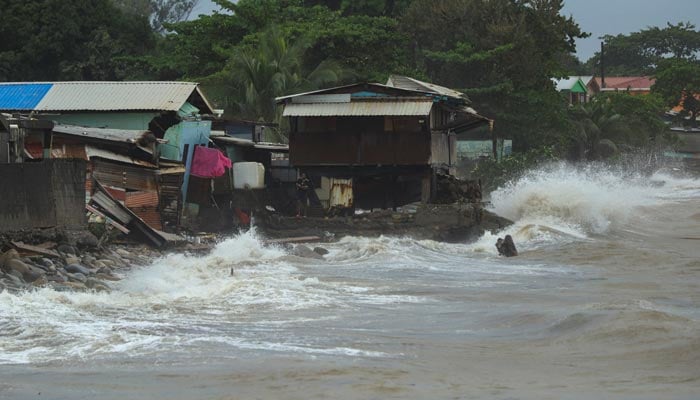 A man stands next to damaged structures during the aftermath of tropical storm Sara, in La Ceiba, Honduras, November 16, 2024. — Reuters