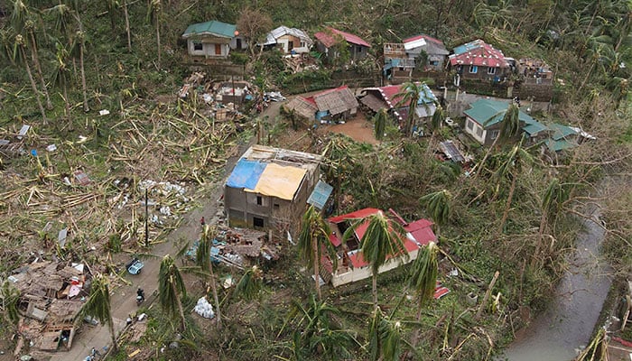 This handout taken on November 17, 2024 and released on November 18 courtesy of Joshua Villegas shows an aerial view of damaged houses amid stripped coconut trees in San Rafael village, Bagamanoc town, Catanduanes province, after Super Typhoon Man-yi hit the province. — AFP