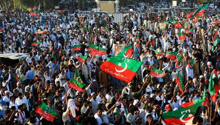 PTI workers wave party flags during a rally in Islamabad. — Reuters/File