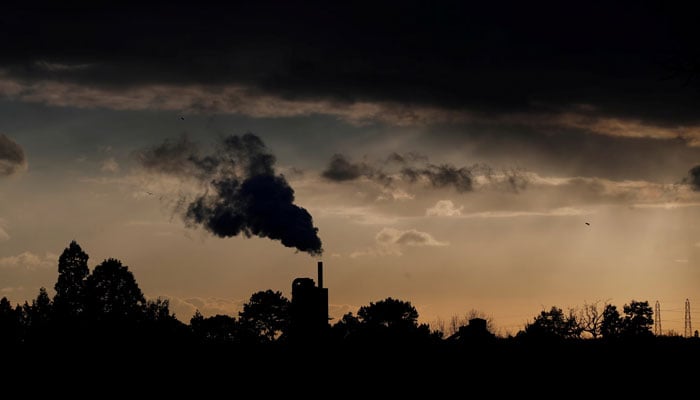 Smoke rises above a factory at sunset in Rugby, Britain February 10, 2021. — Reuters