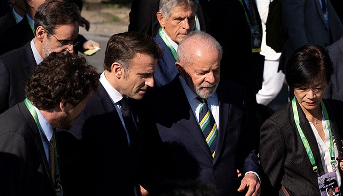 Brazils President Luiz Inacio Lula da Silva and French President Emmanuel Macron walk to join world leaders for a group photo, during the G20 Summit, in Rio de Janeiro, Brazil, November 18, 2024. — Reuters