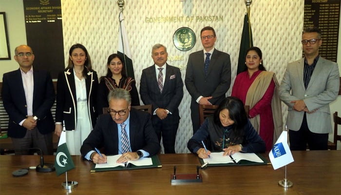 Secretary of the Ministry of Economic Affairs, Dr Kazim Niaz and ADB Country Director, Ms Emma Fan signing the loan agreement during a ceremony attended by senior government and ADB officials on Tuesday. —APP