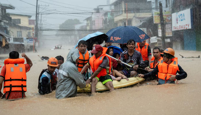 Rescuers assist residents on a boat as they wade through a flooded road following heavy rains brought by Typhoon Gaemi, in Marikina City, Metro Manila, Philippines, July 24, 2024. — Reuters