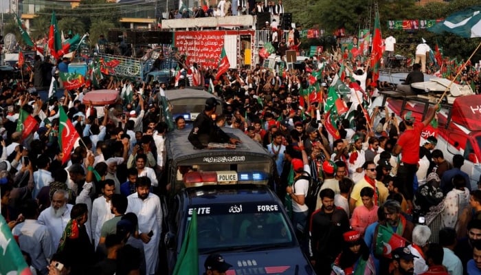 PTI workers participating in protest march in Lahore on October 28, 2022. —Reuters