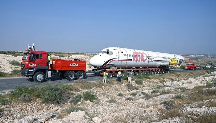 A heavy trailer transporting a used Boeing MD-83 airplane from Karachi to Hyderabad near the airport, November 20. — APP